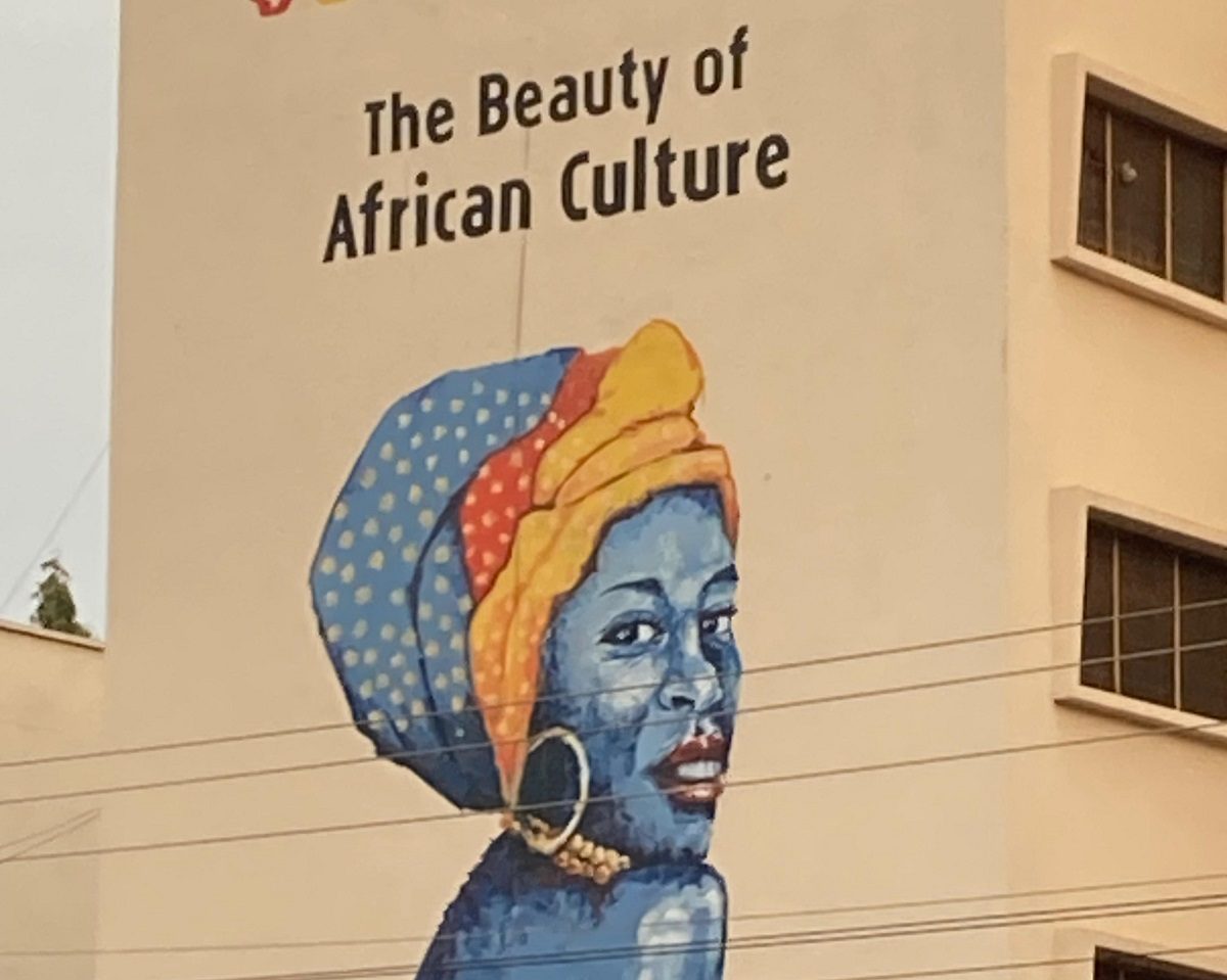 painting of an African lady at a building in Kumasi, Ghana with the text ' The beauty of African culture'