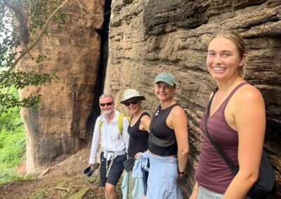 guests posing in front of the rock wall of the mountain of Mercy during a weekend getaway in Ghana